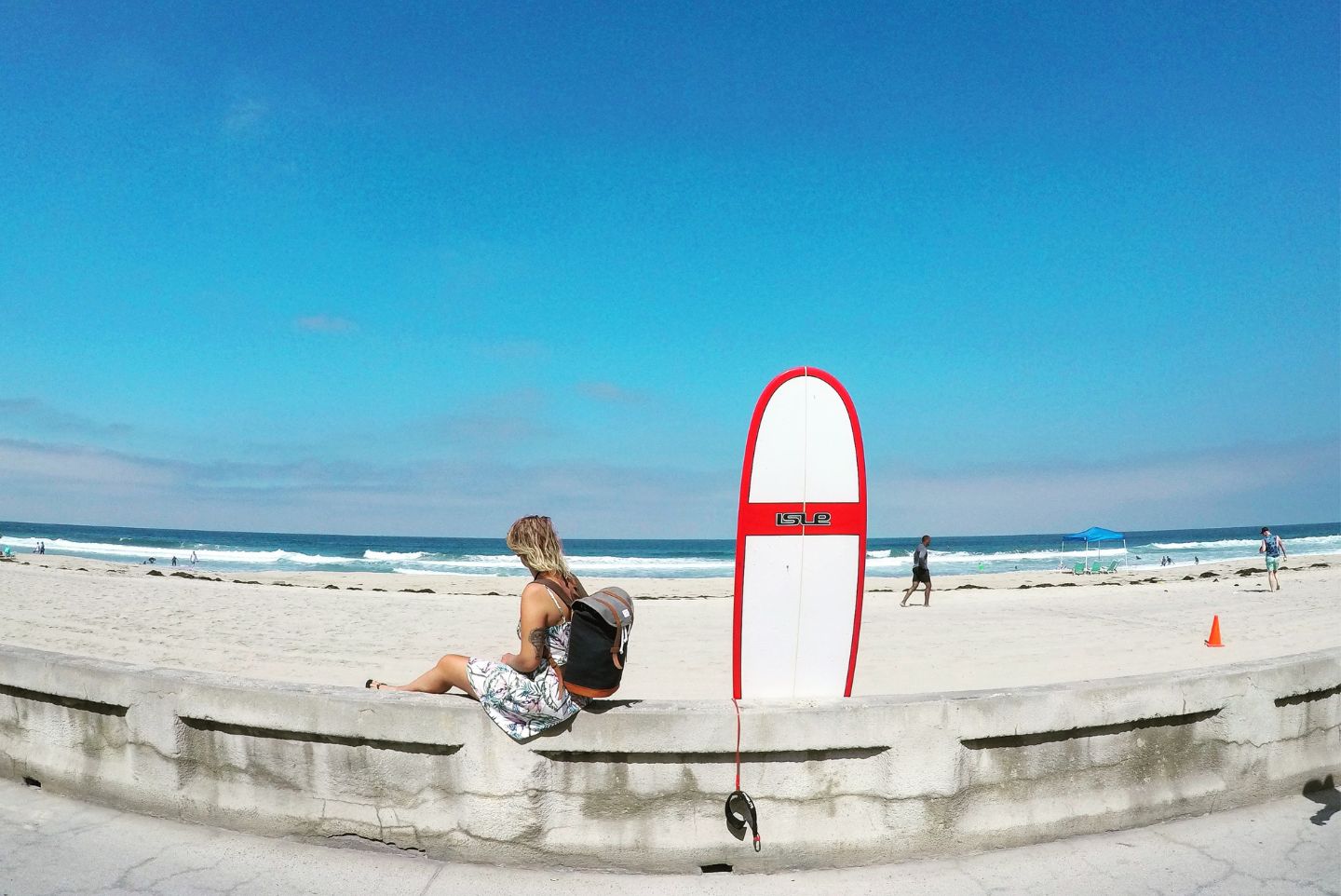 A girl waiting on the sand for her surf lesson in San Diego California