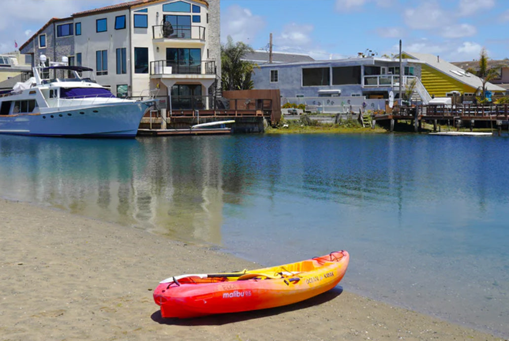 Kayak sitting on the shore of Huntington Harbour in Sunset Beach, California.
