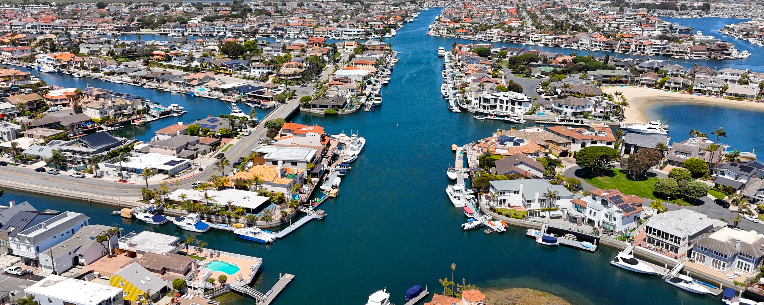 Aerial image of Huntington Harbour near Huntington Beach, California. The calm waters of the canals in Huntington Harbour make it perfect for renting a kayak or stand up paddle board to explore the water.