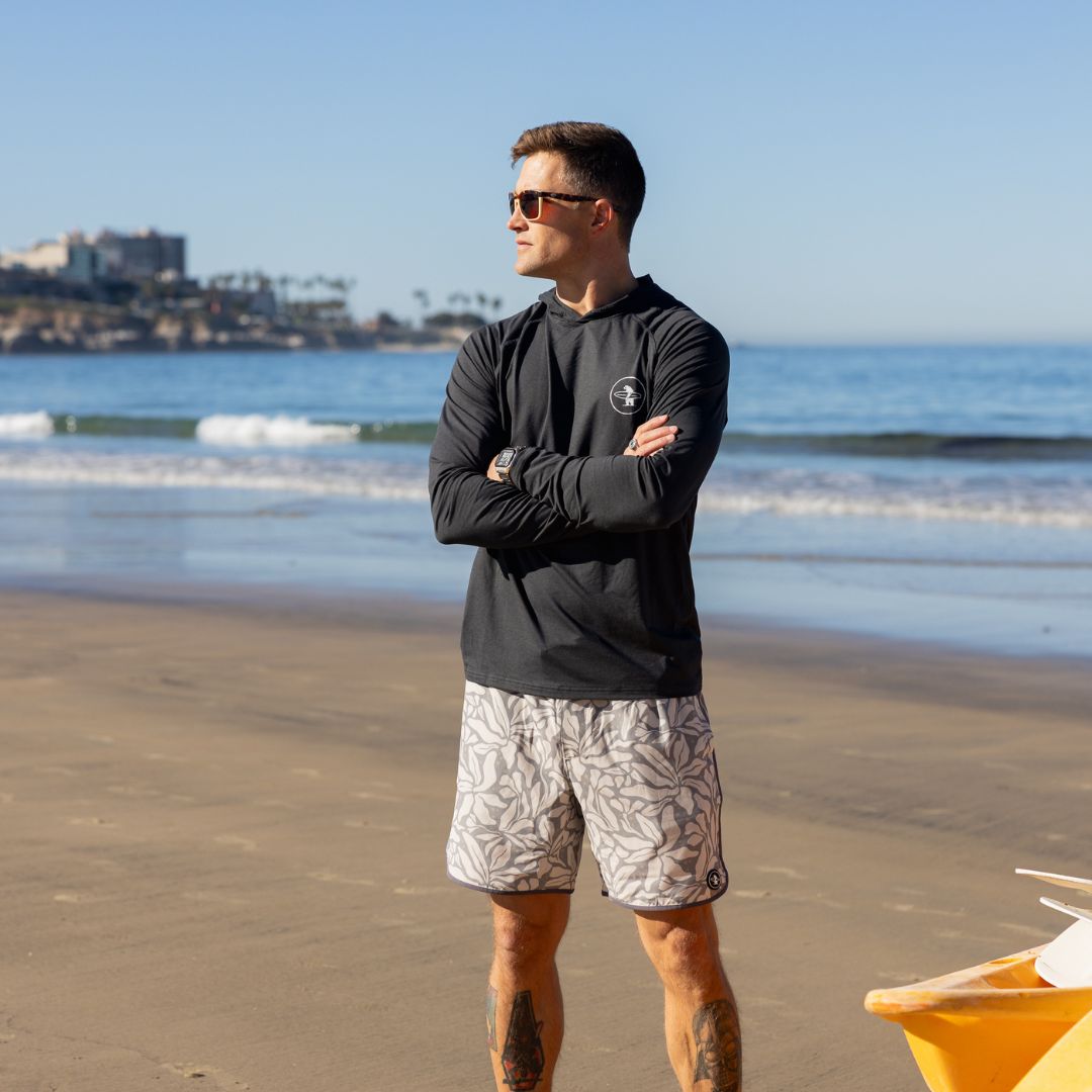 Man on La Jolla Shores wearing Everyday California Breakers SPF Hoodie