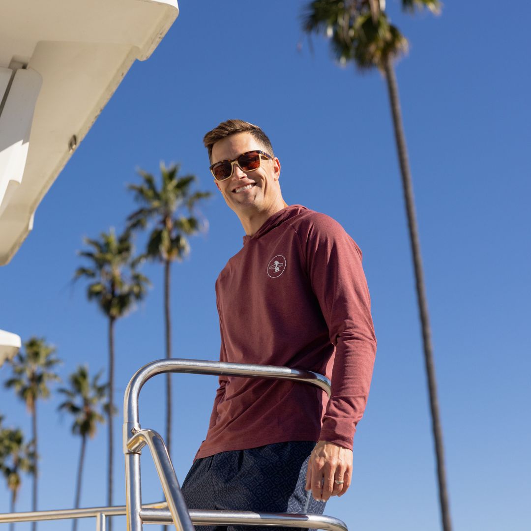 Man on La Jolla Shores wearing Everyday California Breakers SPF Hoodie