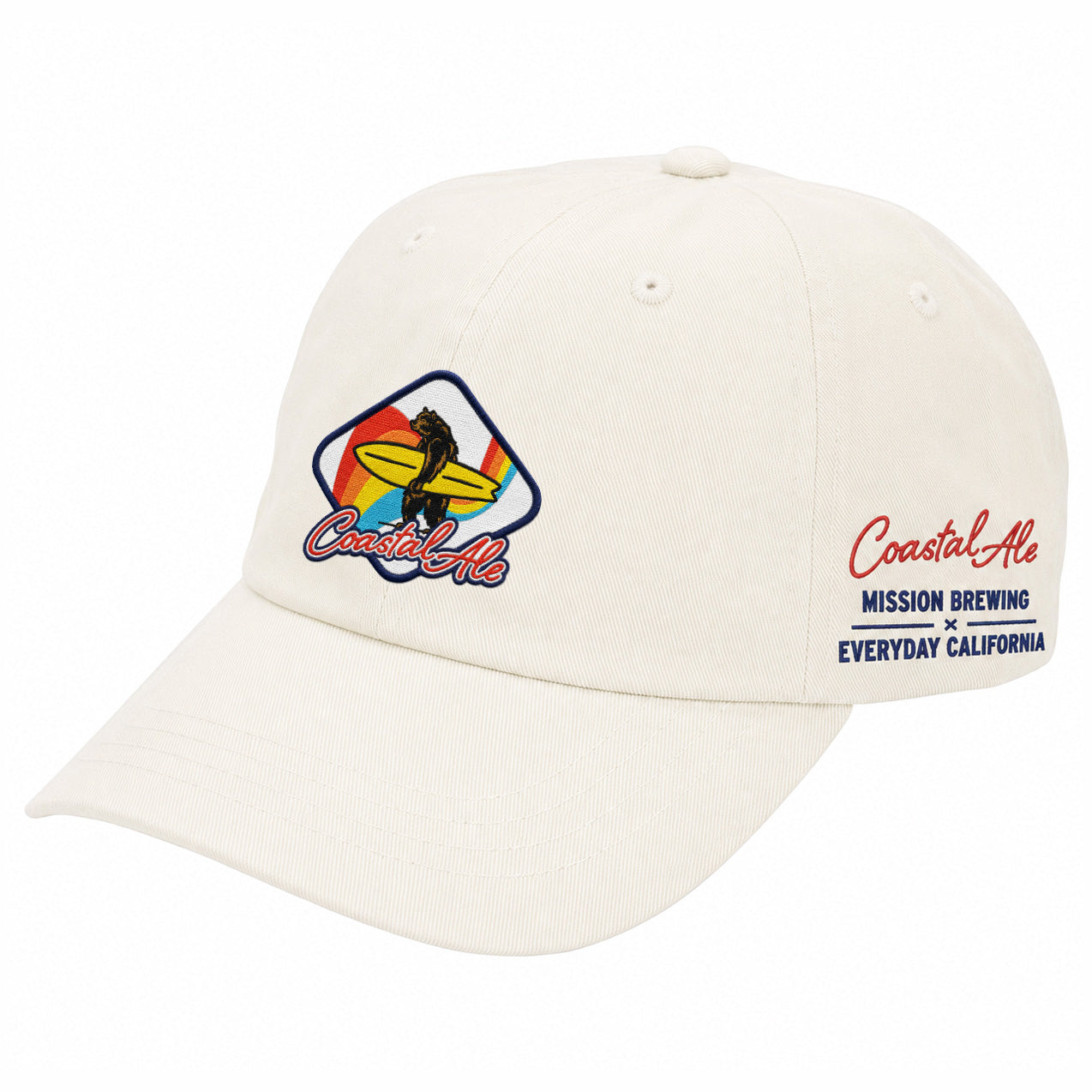 Cream colored twill hat with a bright patch on the front of a bear holding a yellow surfboard with text below that reads "Coastal Ale". Embroidery on the side of the hat reads: Coastal Ale MISSION BREWING X EVERYDAY CALIFORNIA.