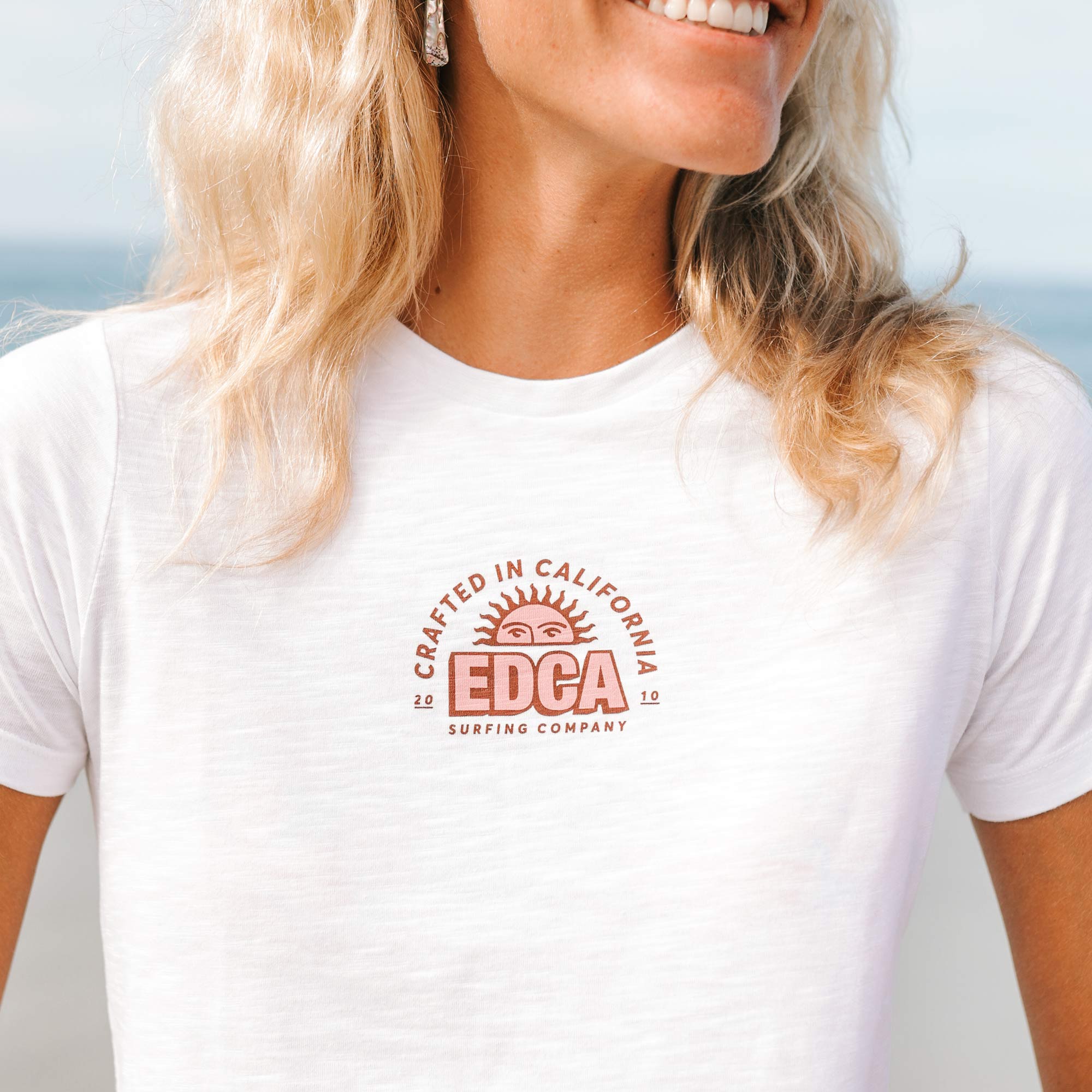 Girl at the beach wearing everyday california San Pedro Tee white front view