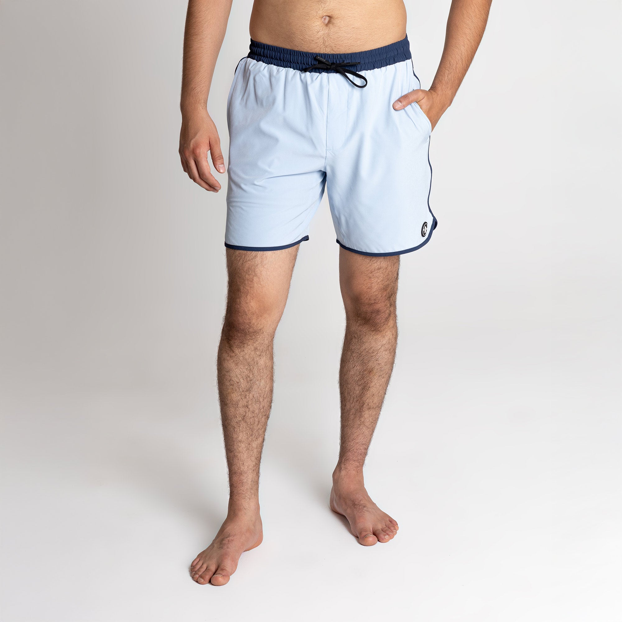Model wearing Everyday Recycled Boardshorts in Marine blue with navy trim and drawstring waistband