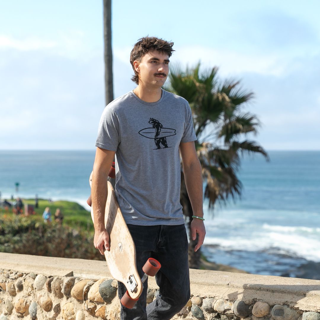 Simply Brutus Tee in Grey from Everyday California. Casual fit, lightweight, breathable, and features Brutus the bear holding a surfboard.
