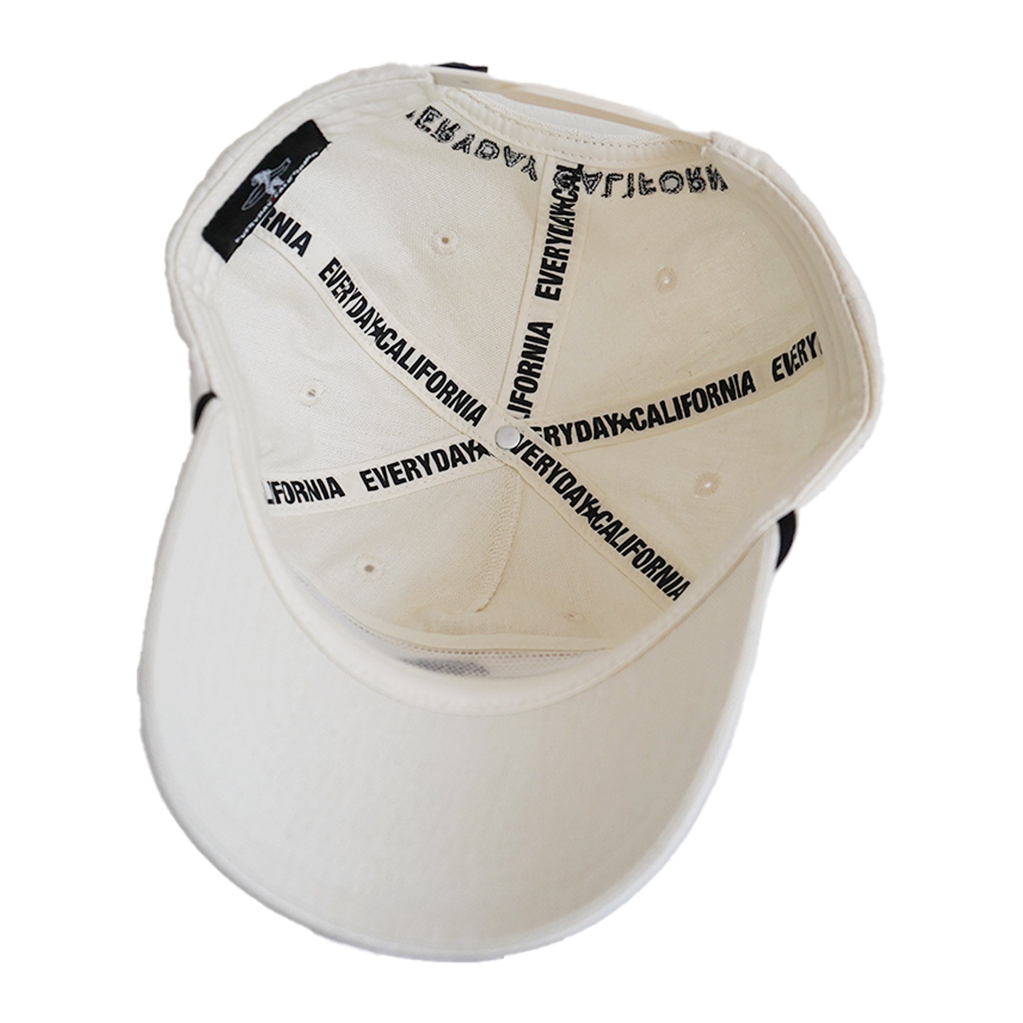 Interior of cream snapback showing "Everyday California" branded tape in black
