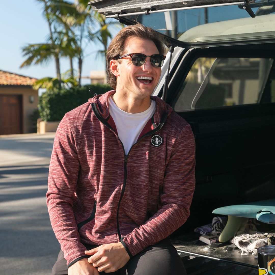 Man laughing in the California sun wearing a lightweight zip from Everyday California