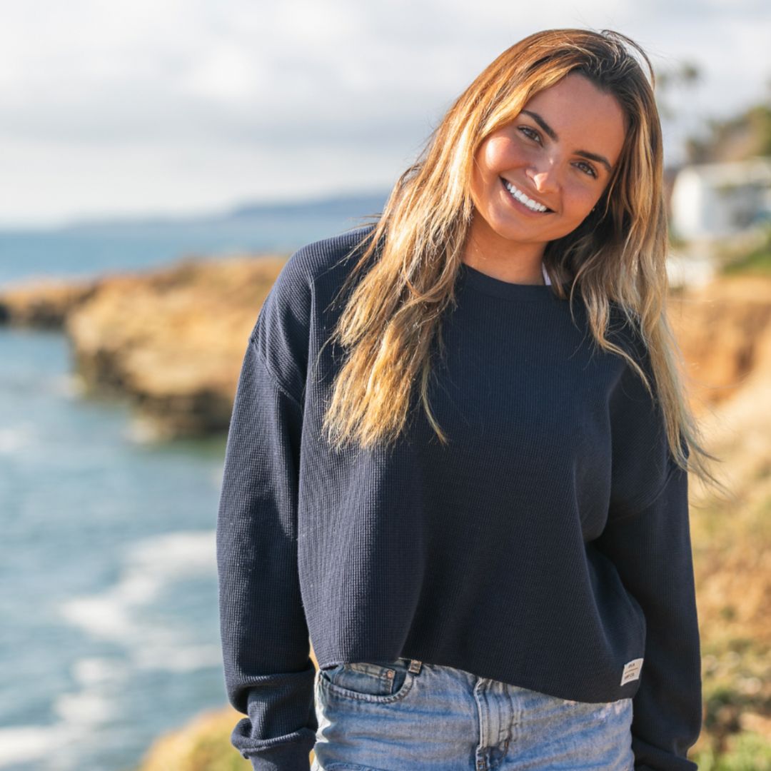 California girl smiling on the cliffs of San Diego in her Sophie waffle knit long sleeve