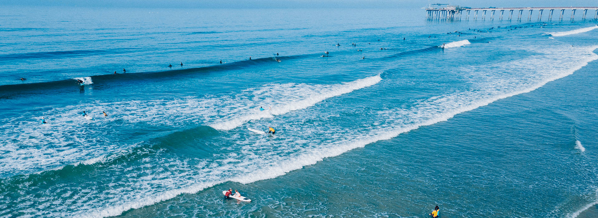 A drone overview of the La Jolla Shores Surfing area in San Diego where the Kid's Summer Surf Camps happen yearly.