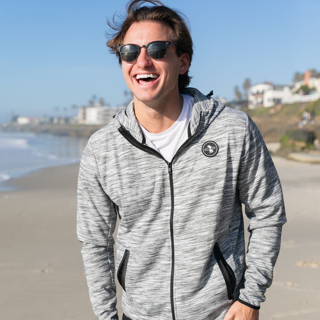 Man laughing on the beaches of Southern California in a White Palisade Zip Up from Everyday California