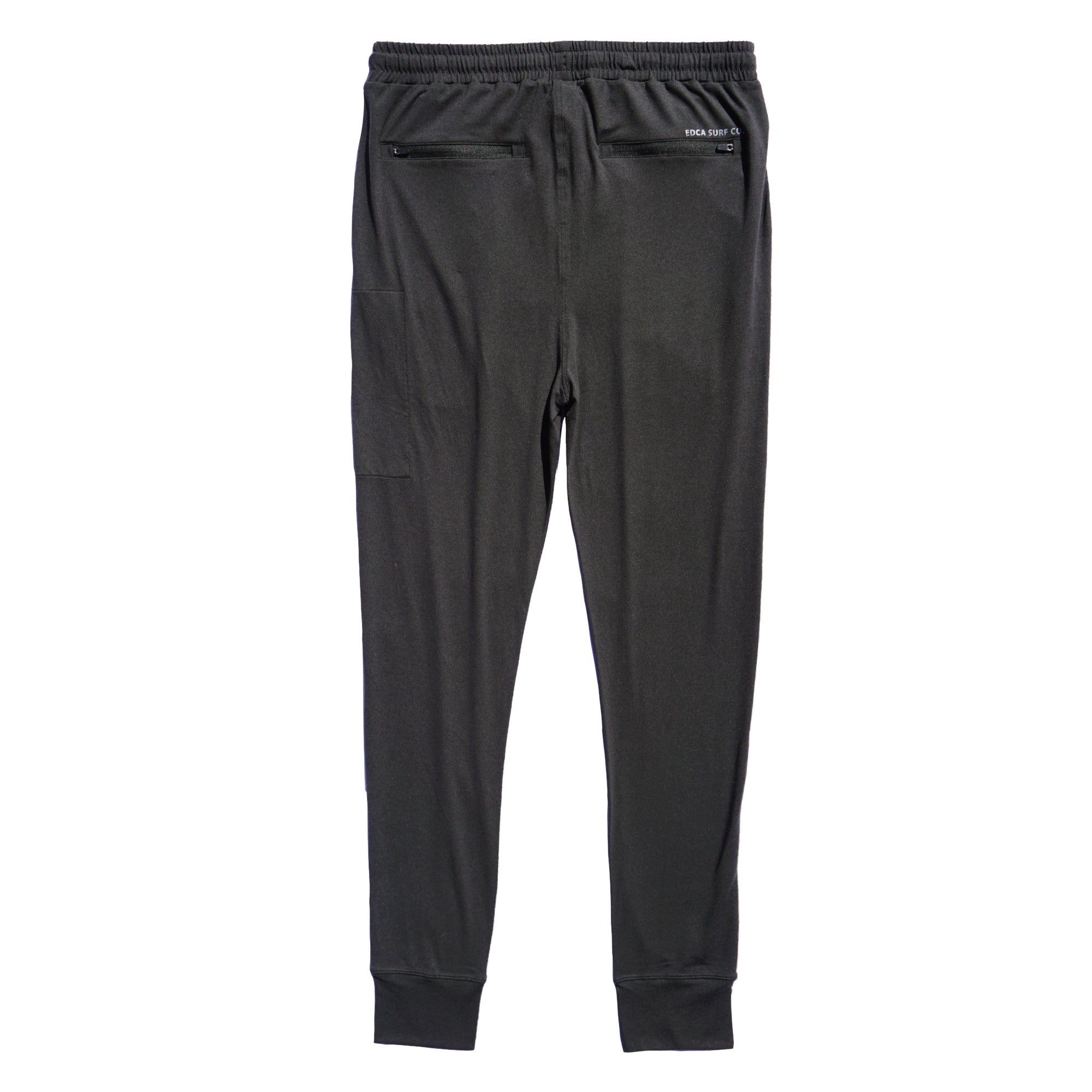 Black Bayside Performance joggers backside image, featuring a small reflective vinyl logo that says 'EDCA SURF CO.' above the back zip pocket.
