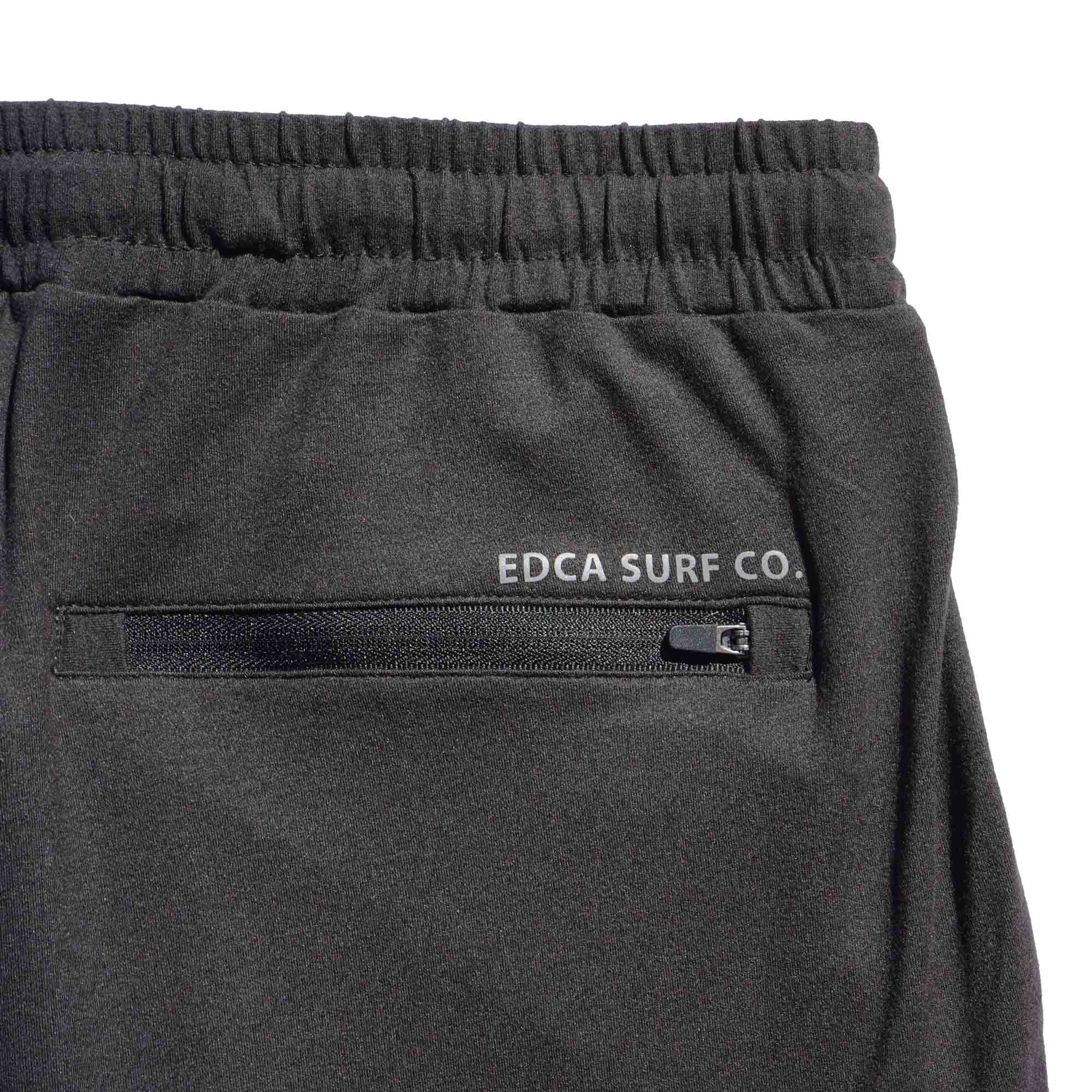 Black Bayside Performance joggers backside image, featuring a small reflective vinyl logo that says 'EDCA SURF CO.' above the back zip pocket.