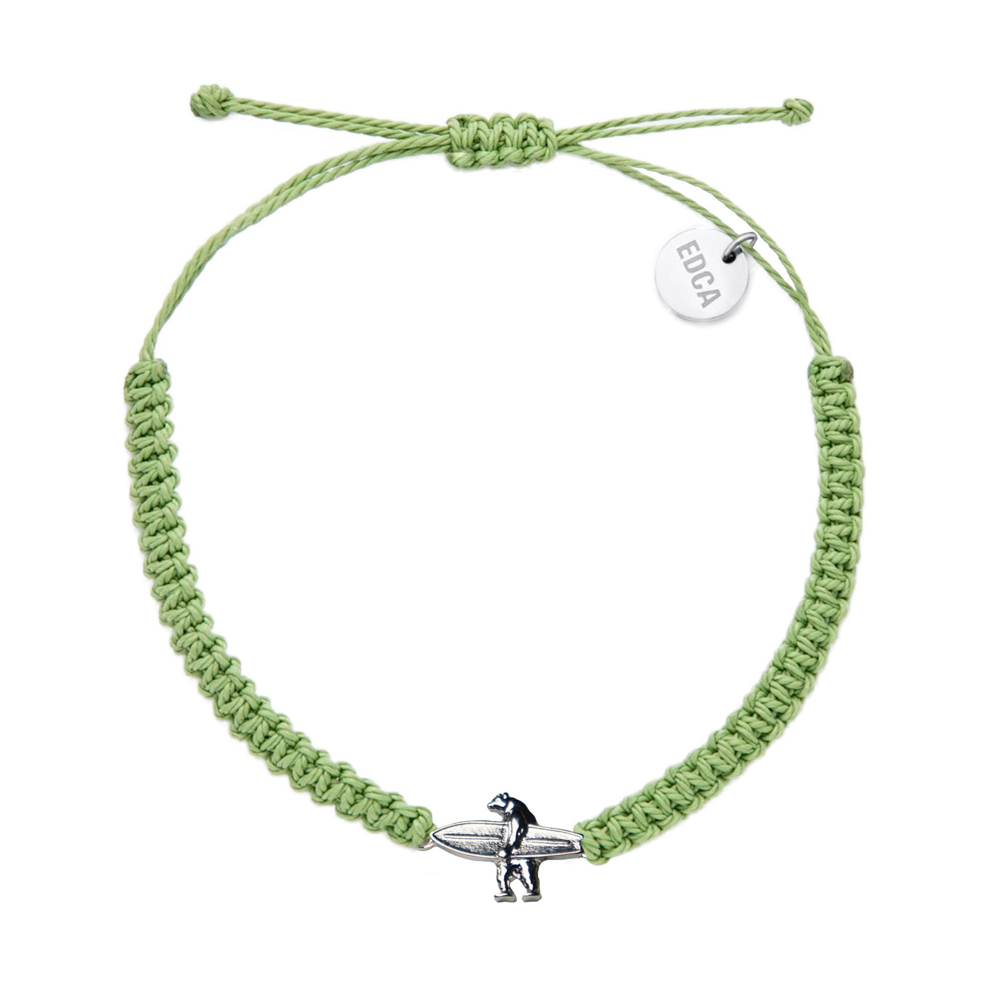 A green woven charm bracelet with a silver charm shaped like a bear, featuring a small tag with the brand name 'EDCA'.