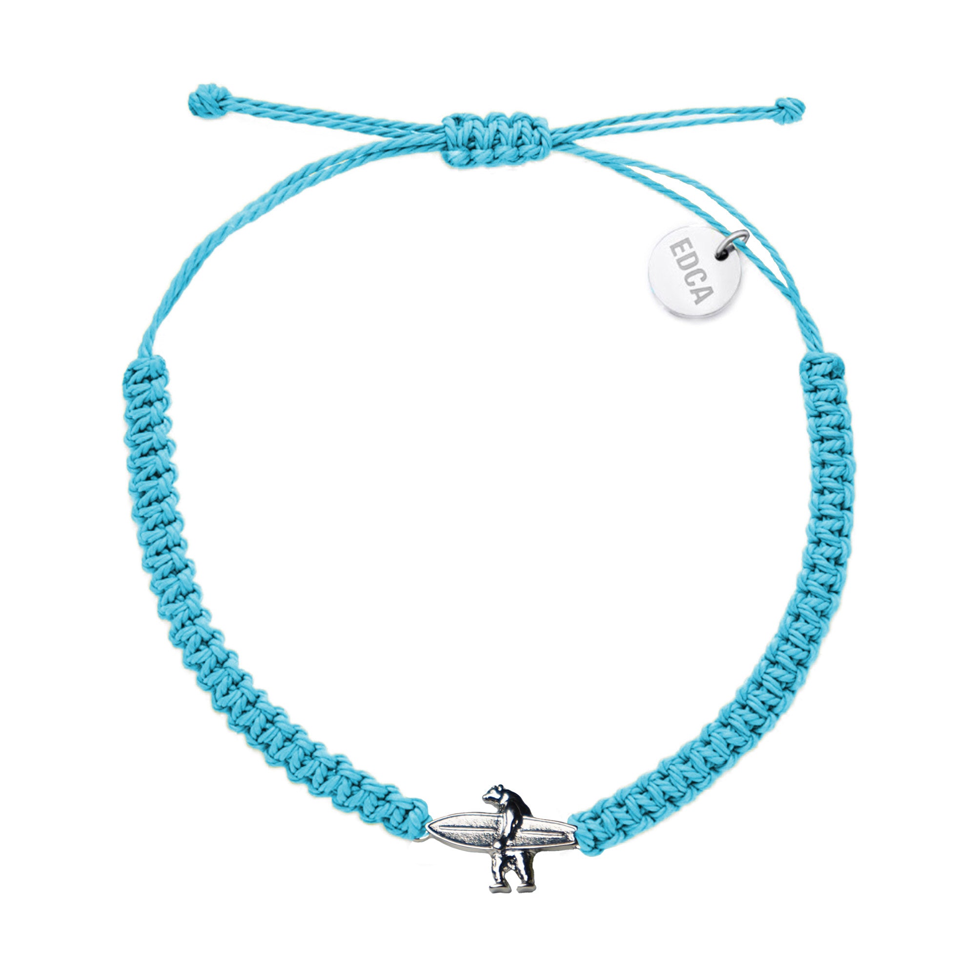 Ocean blue woven charm bracelet featuring a metal charm of a bear holding a surfboard in the center, and a circular charm featuring the word 'EDCA' near the edge.
