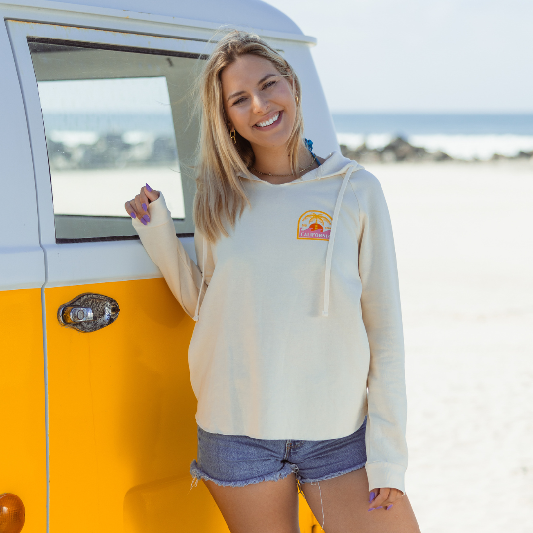 The California Sunshine Club Hoodie on Kate in Coronado next to a yellow VW bus
