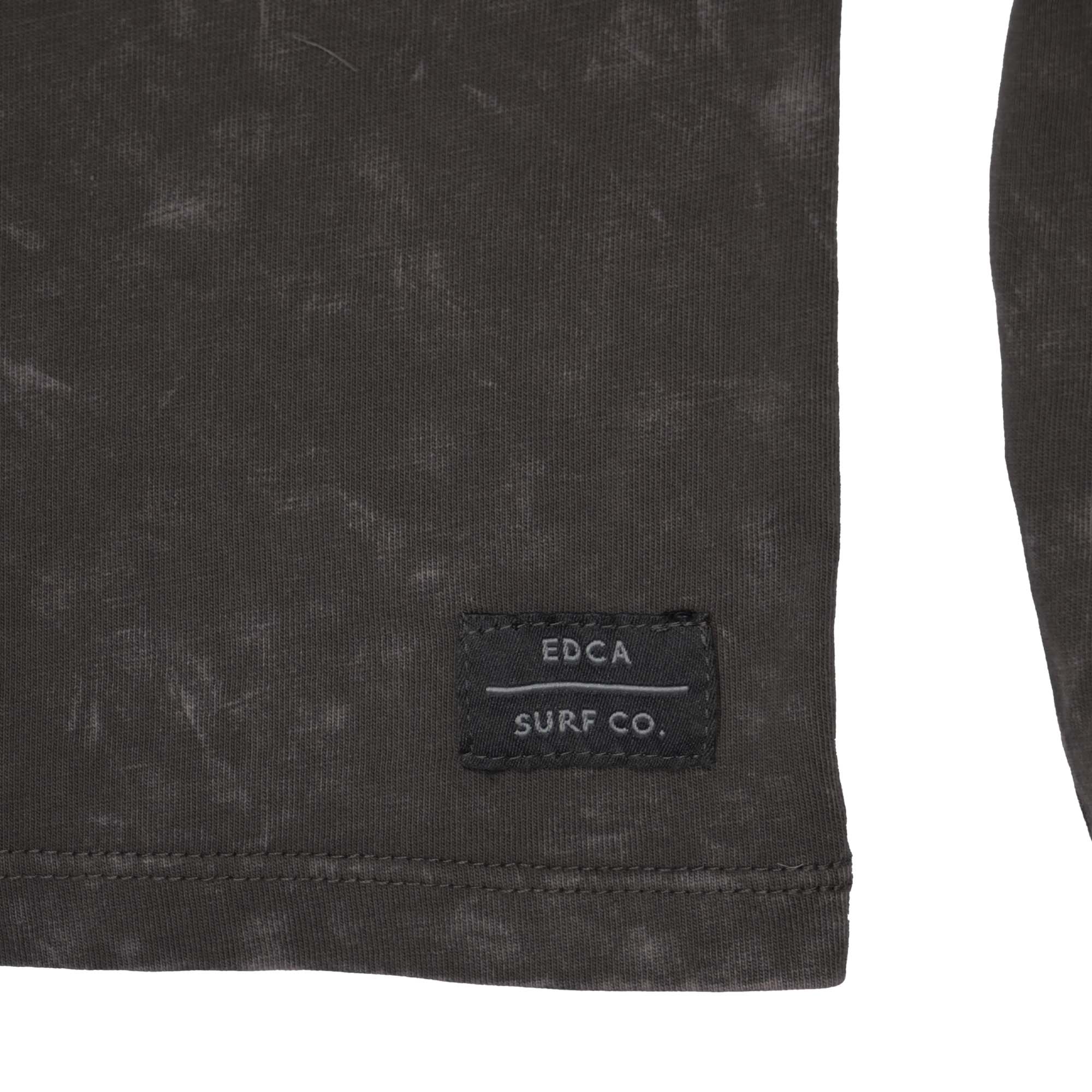 Zoomed in bottom right corner of Everyday California henley hoodie. The stitched patch reads "EDCA Surf Co."