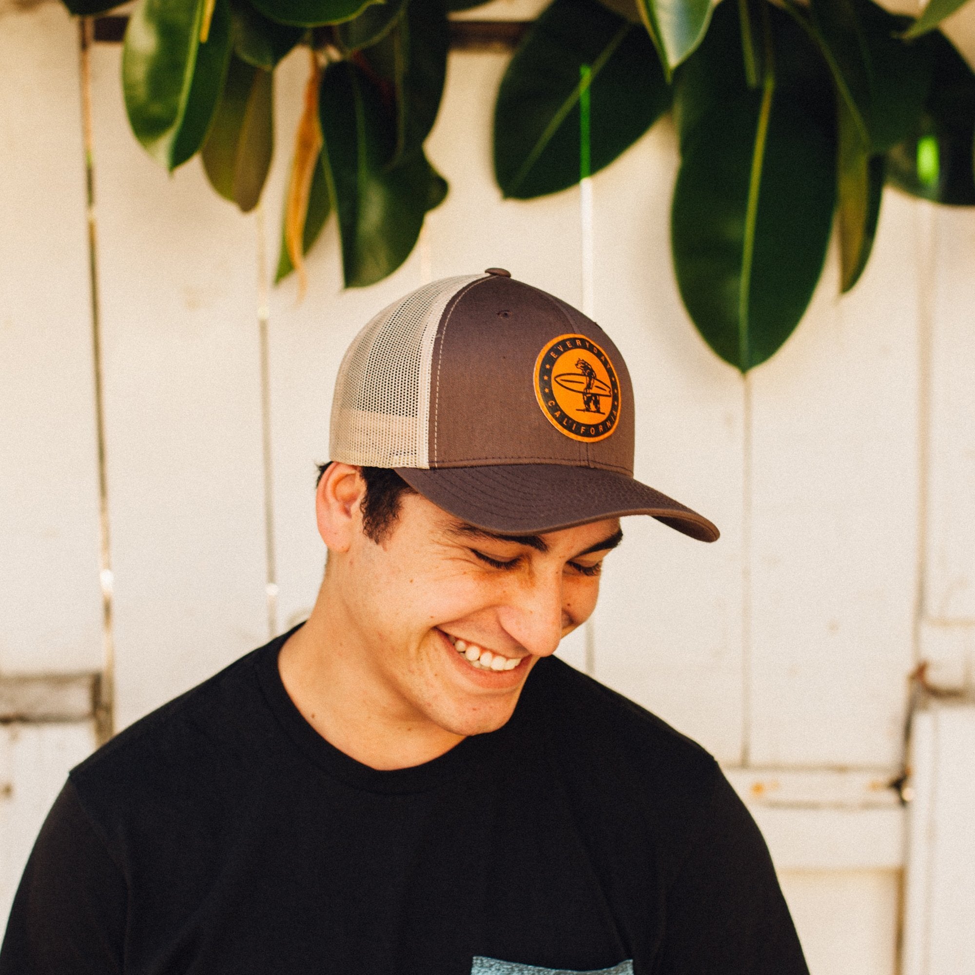 Brown and white hat with Everyday California logo on cork colored patch on model