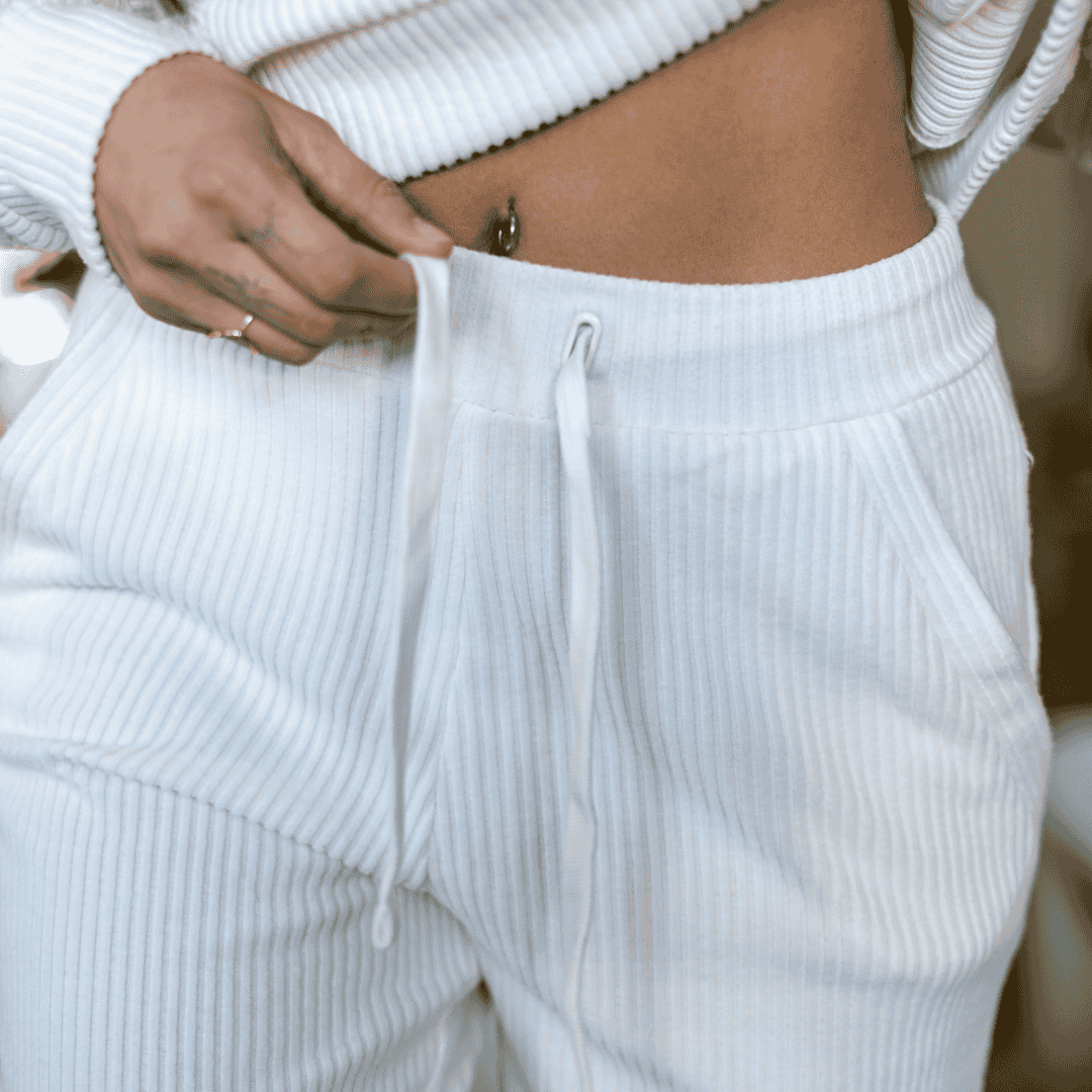 Closeup image of the frontside of the Malibu Ribbed Joggers, showing the detail of the ribbed cotton fabric and the elastic waistband with drawcord.