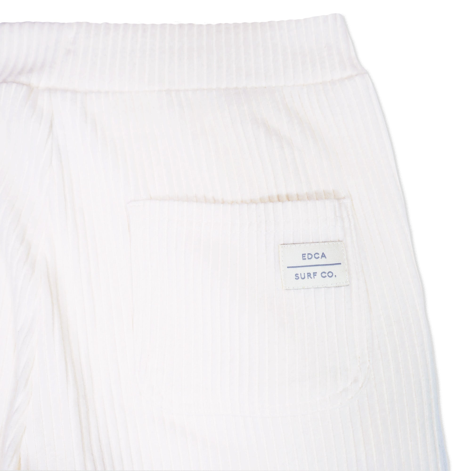 Back right pocket of Every California Joggers. Close up photo of "EDCA Surf CO." patch and ribbed texture.