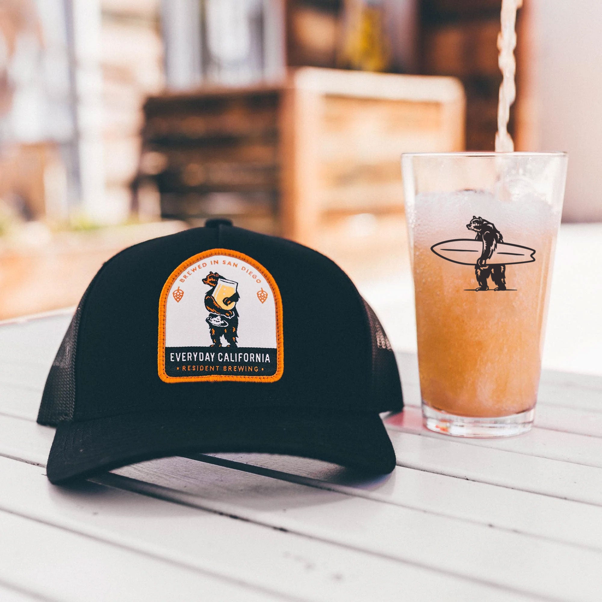 Everyday California hat with a beer in an Everyday California pint glass