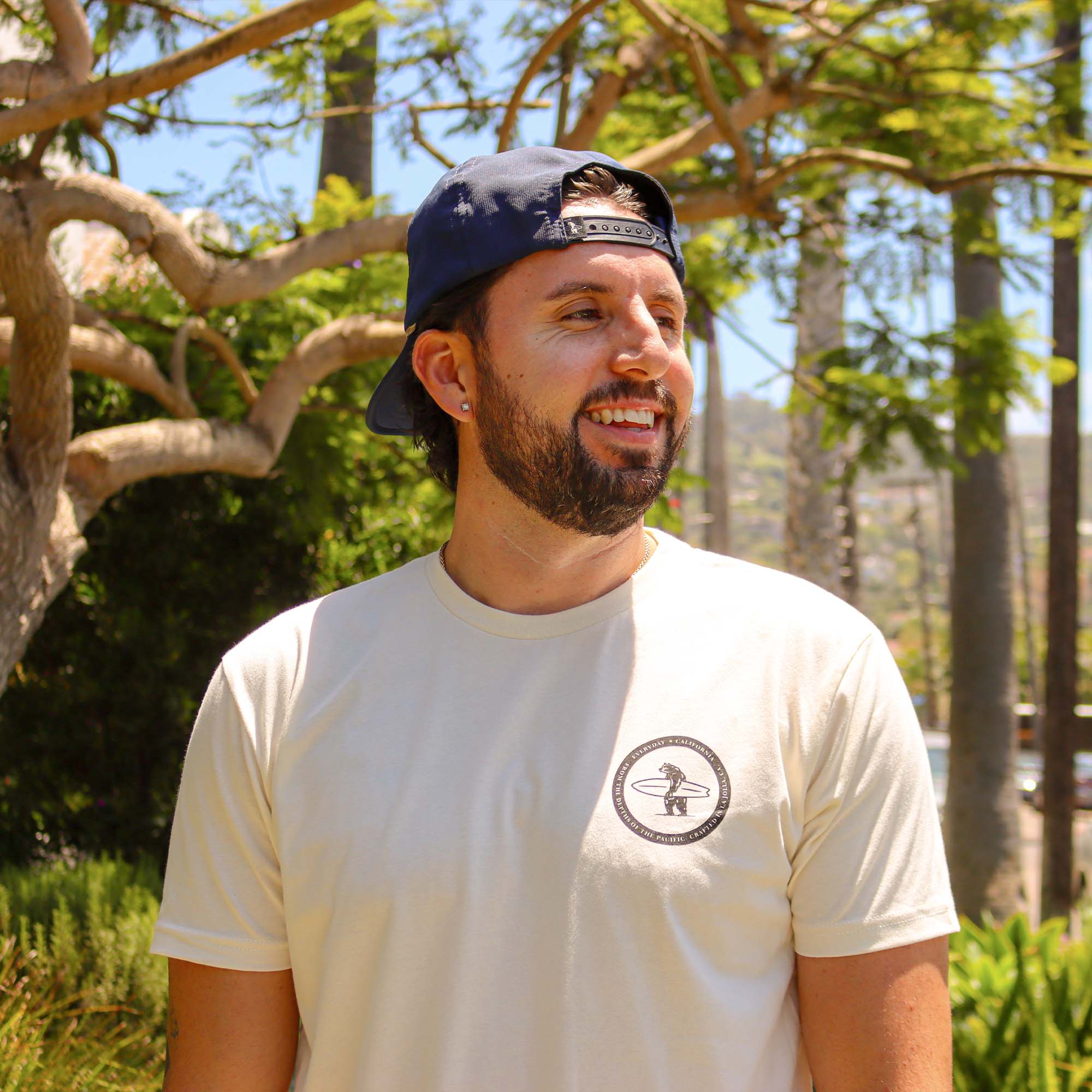 A model showcasing the men's Salty tee which showcases Brutus in the top left corner