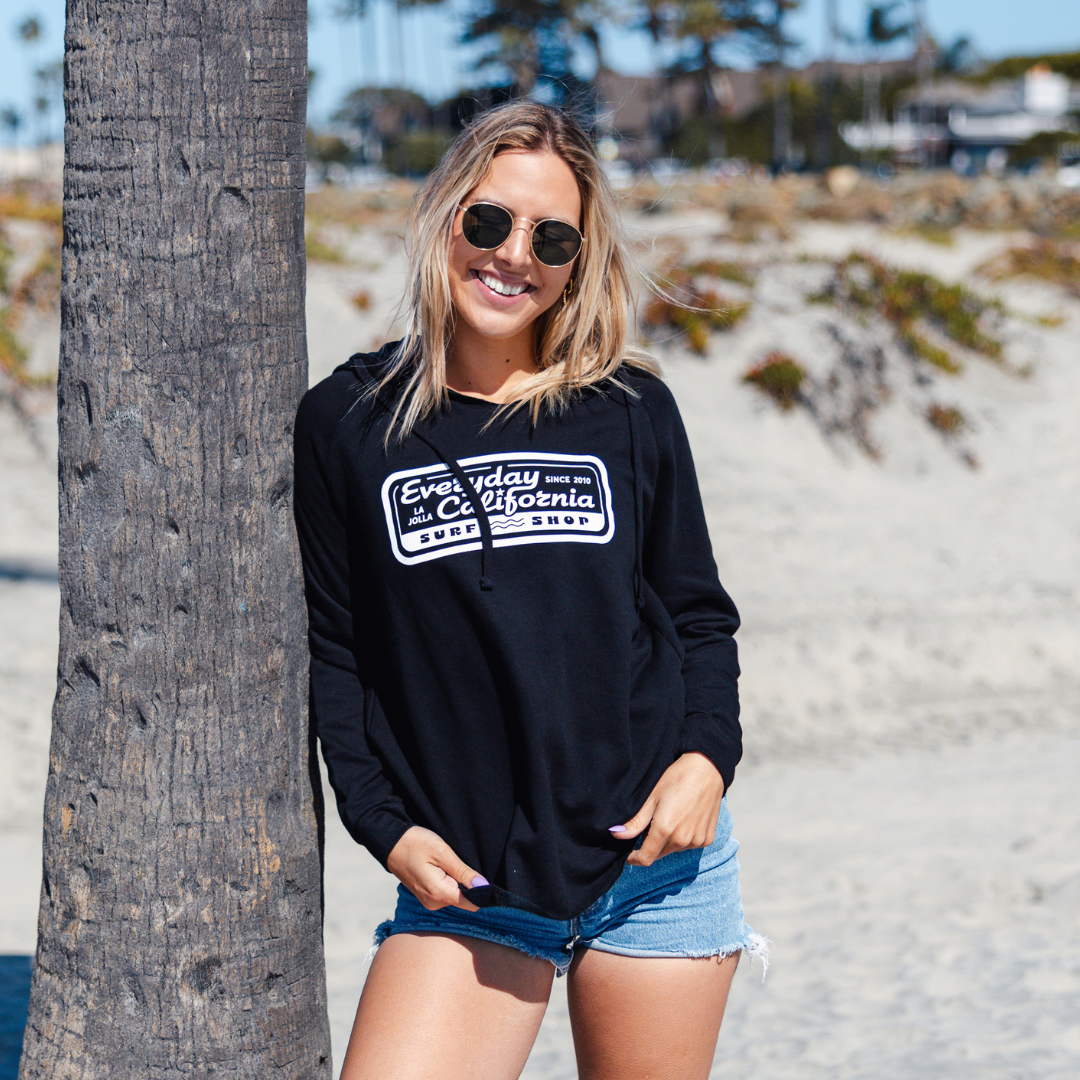 Kate wearing Everyday California Surf Shop Hoodie in Black on Coronado Island in San Diego