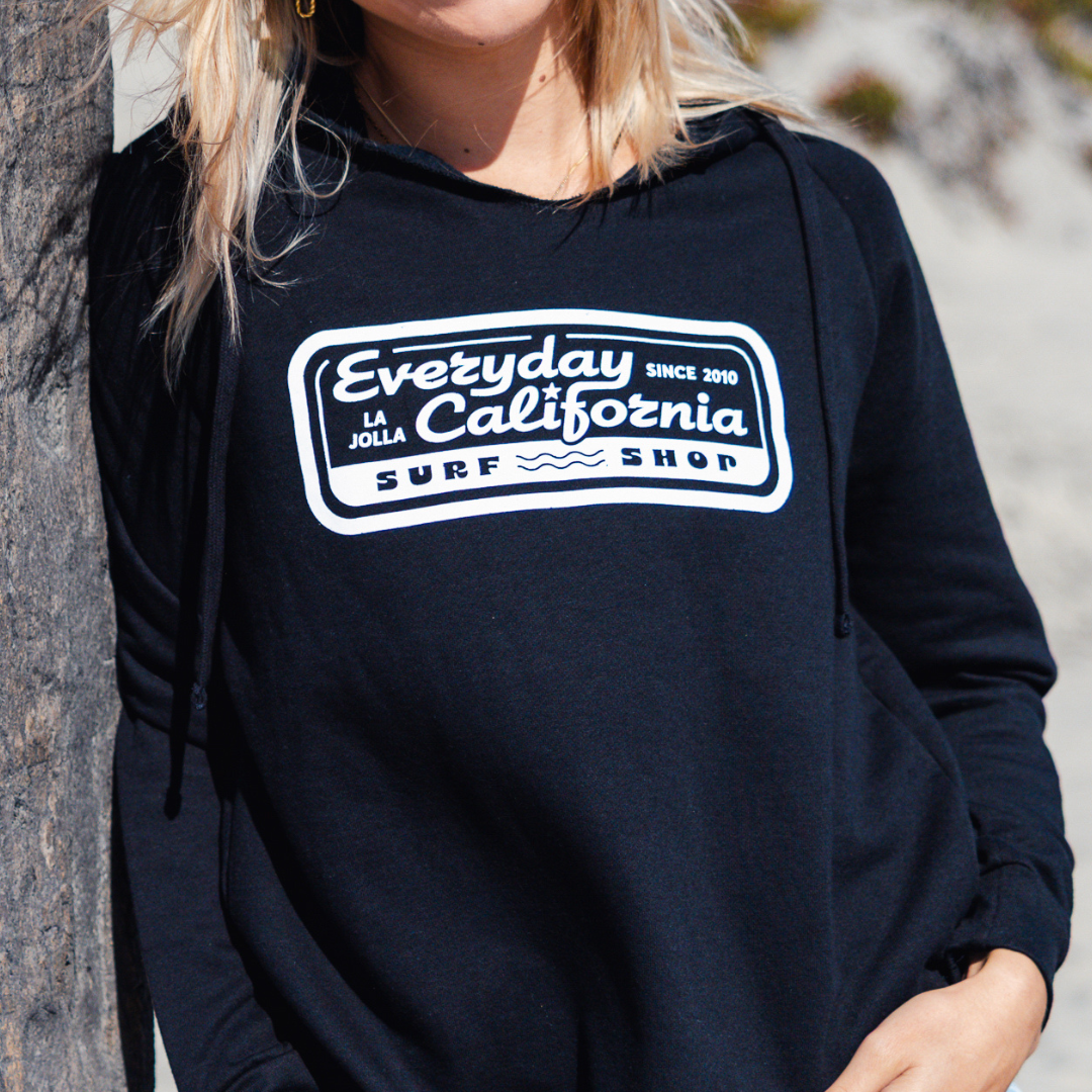 Kate wearing Everyday California Surf Shop Hoodie in Black on Coronado Island in San Diego