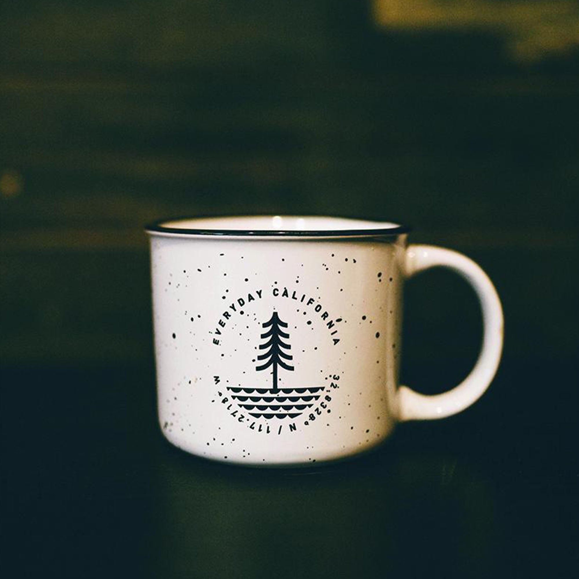 Everyday California Campfire Mug -  High-quality ceramic, speckled off-white mug with Everyday California Camping Logo on one side and Brutus the Bear on the other side. 