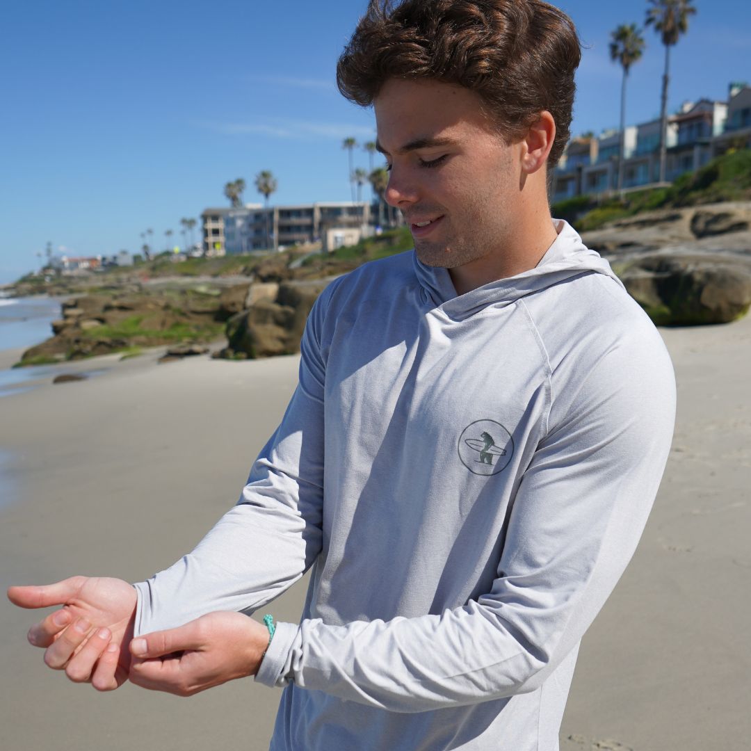 Model wearing Everyday California Breaker UPF50 Sand Resistant Hoodie in Grey on beach