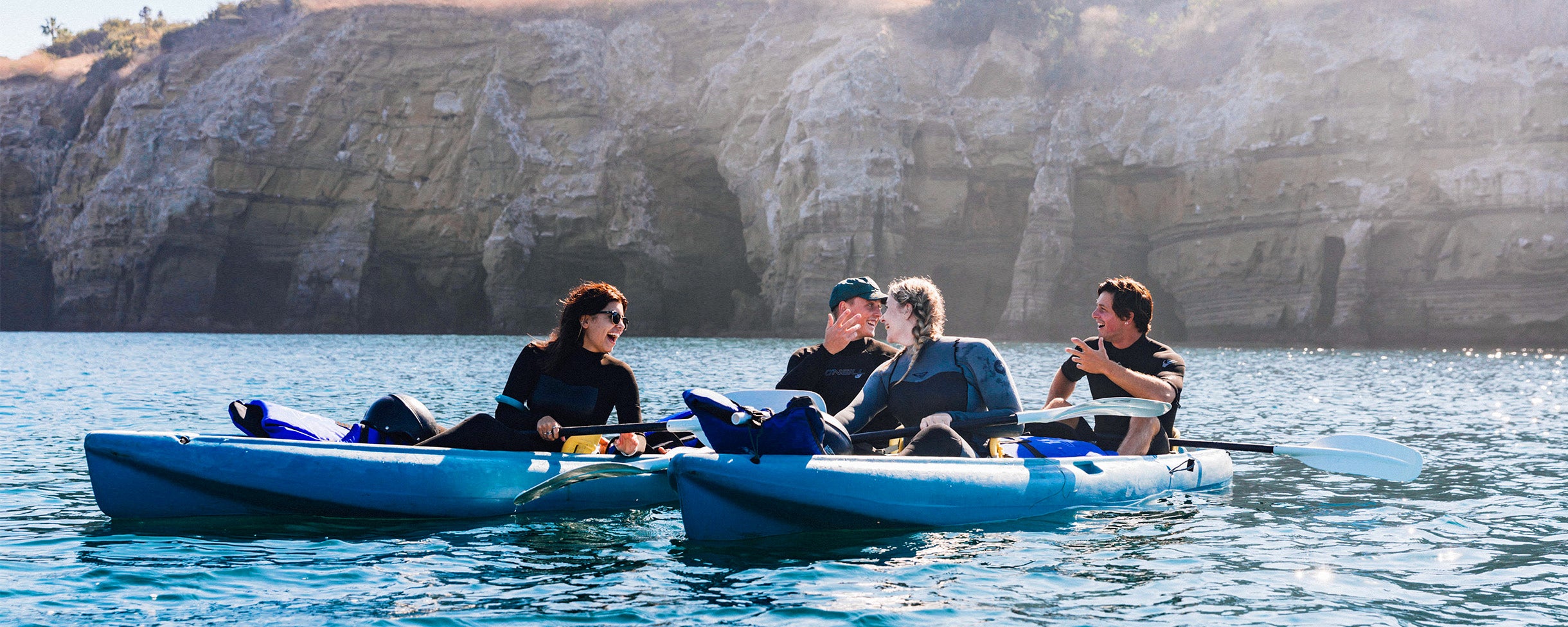 Kayakers laughing on the Pacific Ocean with Everyday California Kayak Rentals at the La Jolla Ecological Reserve.