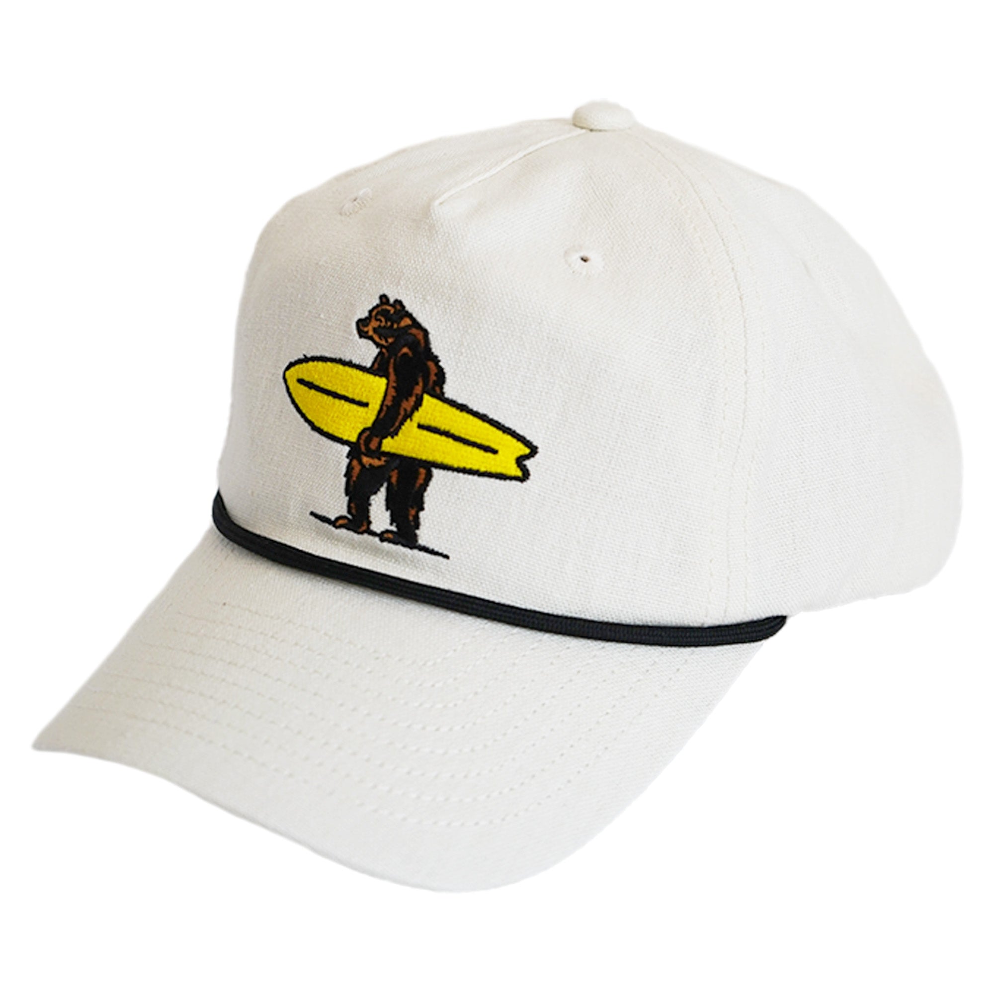 Cream canvas snapback with embroidered Brutus the surfing bear holding a yellow longboard and black rope brim detail