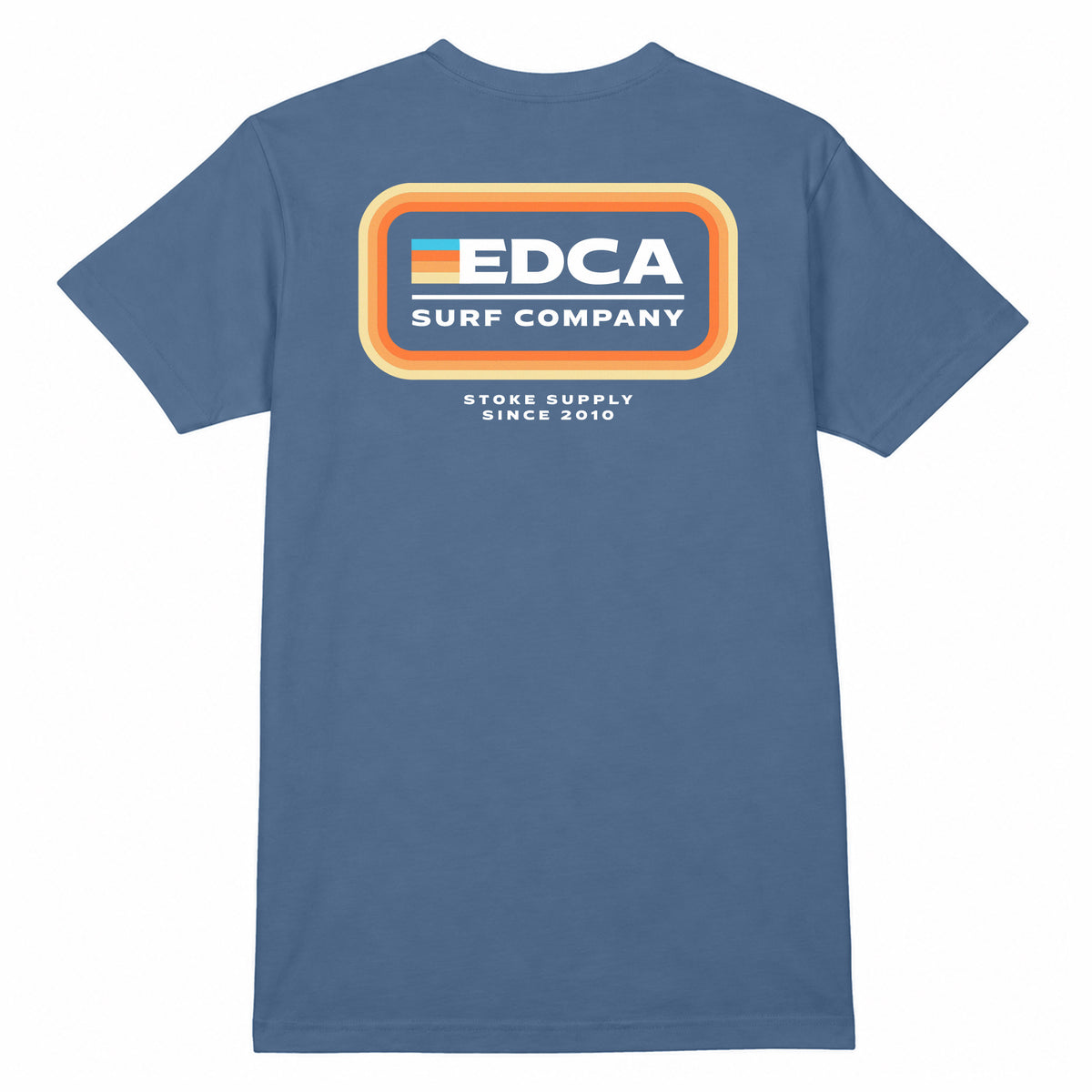 A blue short-sleeve t-shirt with a retro-style graphic on the chest featuring the text 'EDCA SURF COMPANY' inside an orange and yellow rounded rectangle, with 'STOKE SUPPLY SINCE 2010' printed below it.