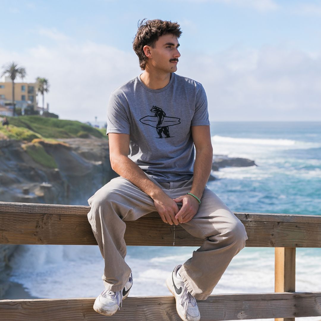 Simply Brutus Tee in Grey from Everyday California. Casual fit, lightweight, breathable, and features Brutus the bear holding a surfboard