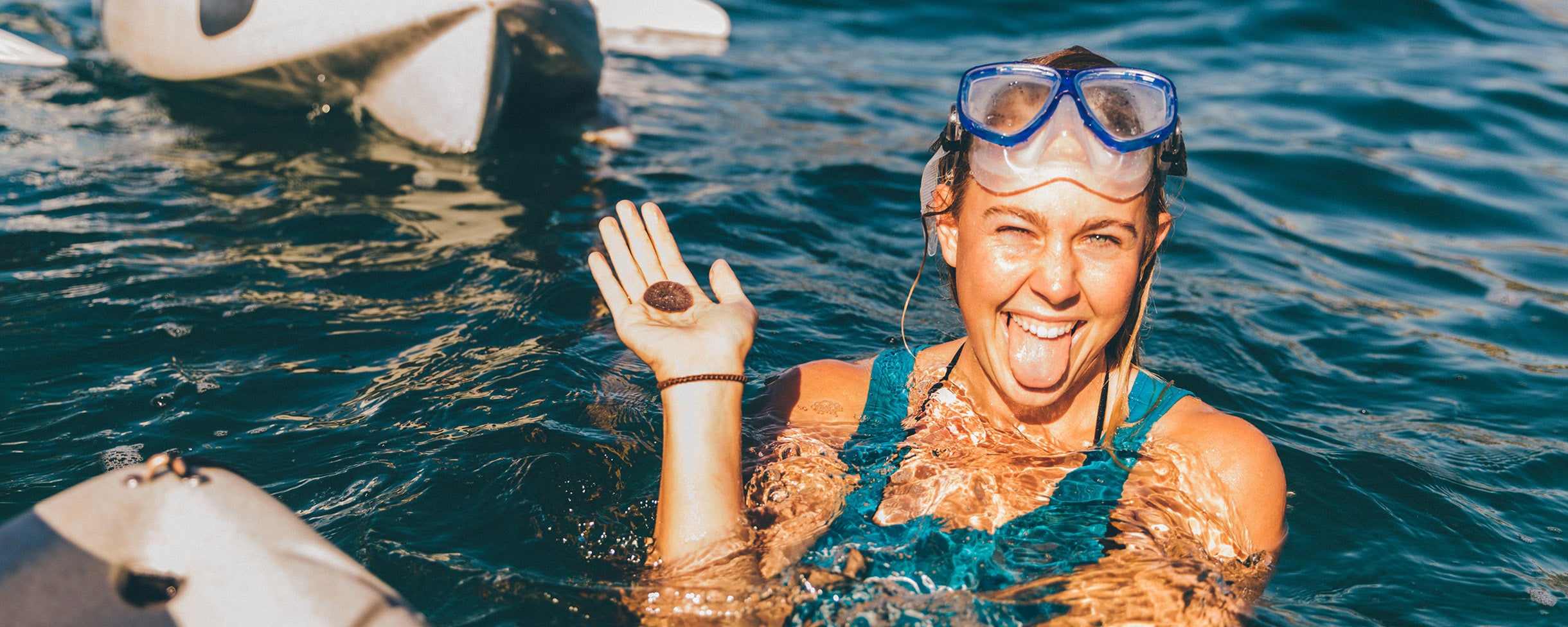 Photo of a tour guide at Everyday California on a kayak and snorkel tour holding a sand dollar in her hand