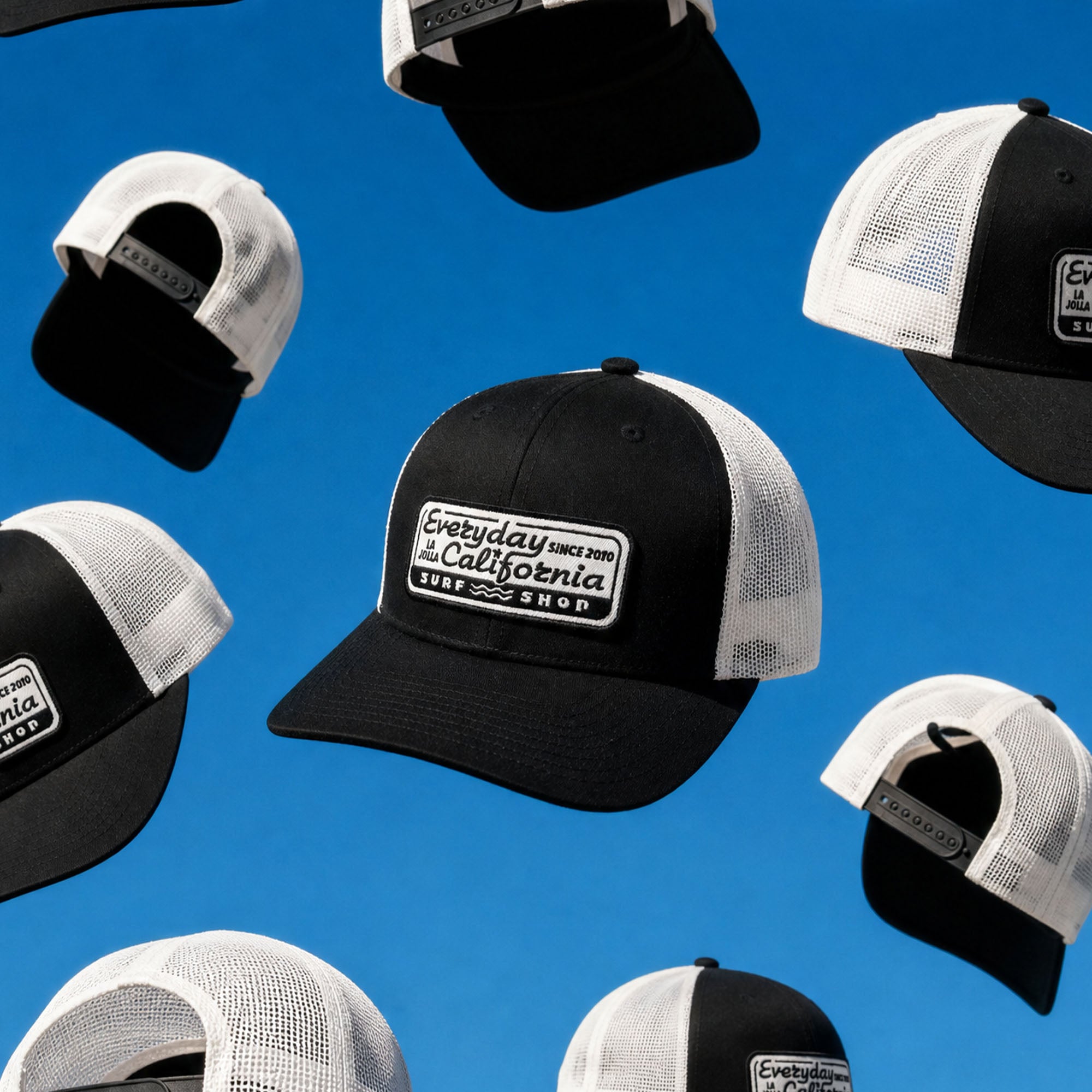Black and white caps with a visible brand logo on a blue background