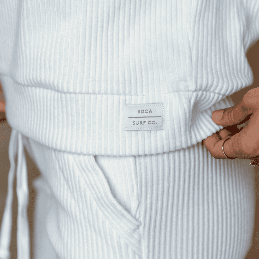 Closeup image of the minimal branded woven label on the malibu hoodie. 