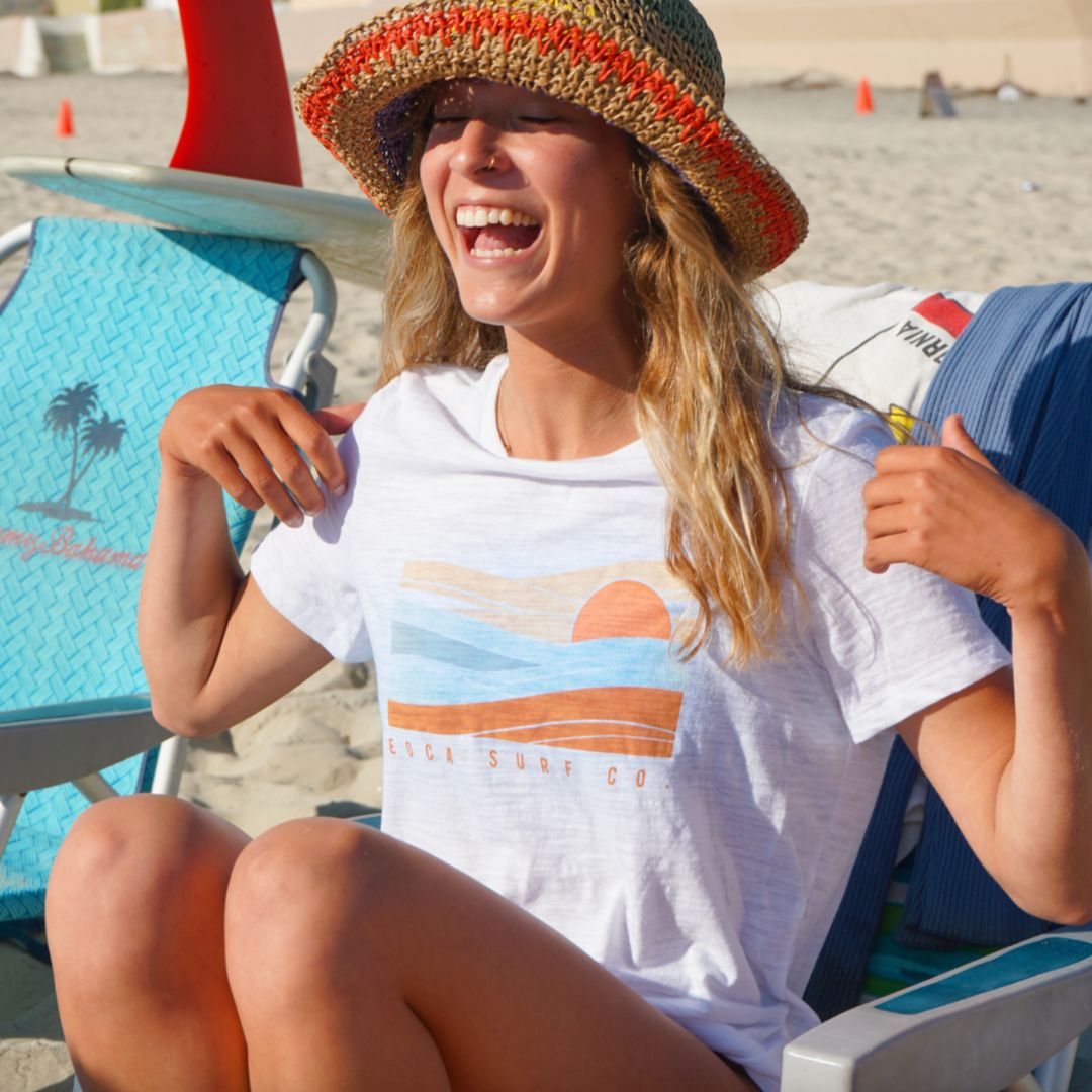 cute California girl on the beach enjoying the sun in her white san onofre tee